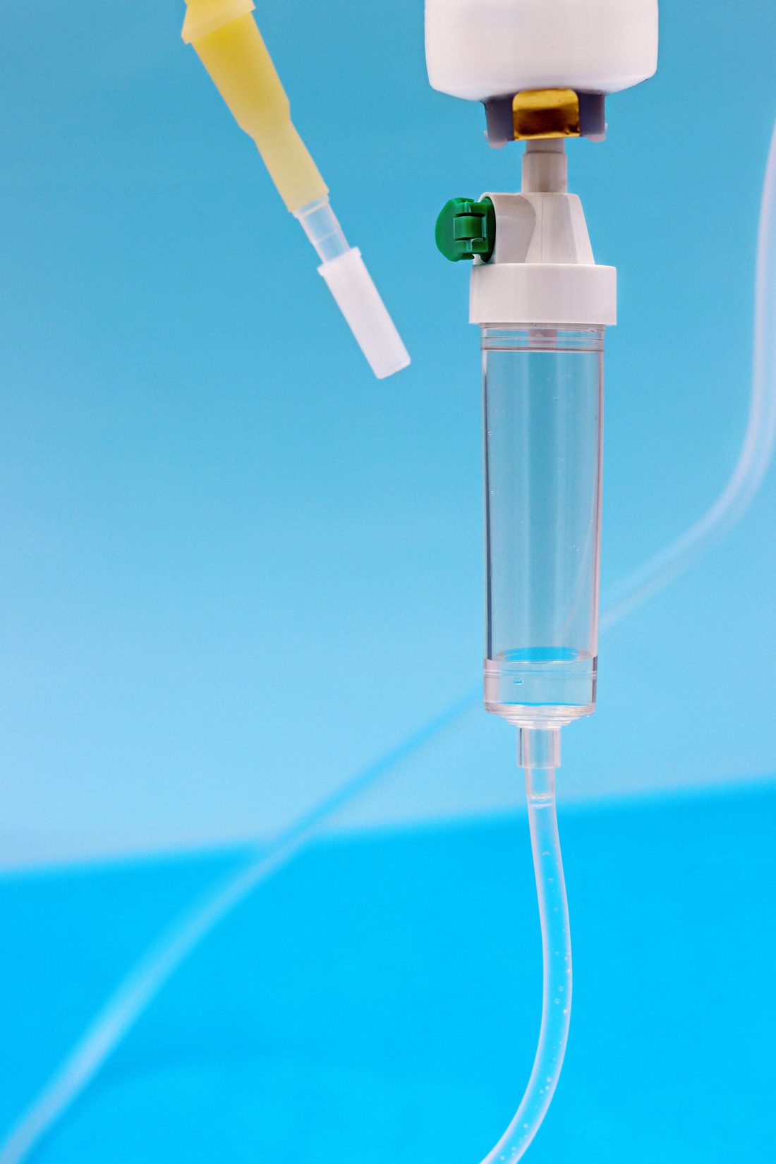 Close up of an infusion set drip chamber and tubing