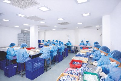 Production team at work in a clean assembly hall